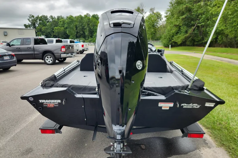 Slide: The Image of 2023 Tracker Pro Team 190 TX boat with Mercury engine, parked outdoors. - 3