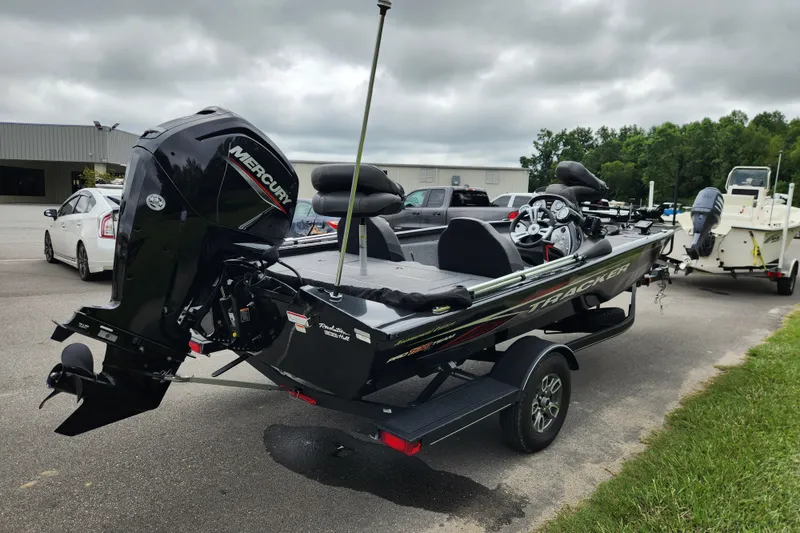Slide: The Image of 2023 Tracker Pro Team 190 TX boat with Mercury engine on trailer, parked outdoors. - 4