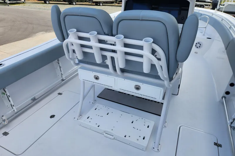 Slide: The Image of 2026 Sportsman Open 252 Center Console boat interior with rod holders and seating. - 11
