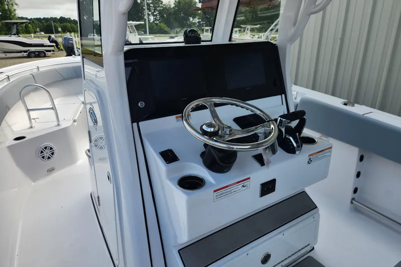 Slide: The Image of 2026 Sportsman Open 252 Center Console boat interior with steering wheel and control panel. - 8
