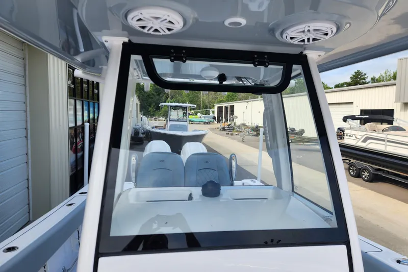 Slide: The Image of 2026 Sportsman Open 252 Center Console boat interior with modern design and seating. - 9