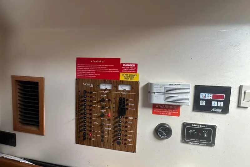Slide: The Image of Control panel of a 2002 Mainship Pilot 34 boat with safety warnings. - 22