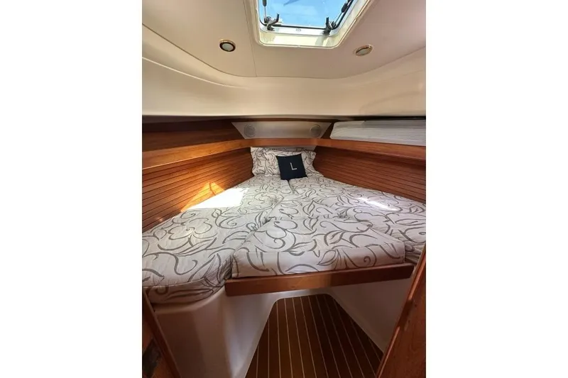 Slide: The Image of Cozy cabin interior of 2002 Mainship Pilot 34 with floral bedding and skylight. - 23