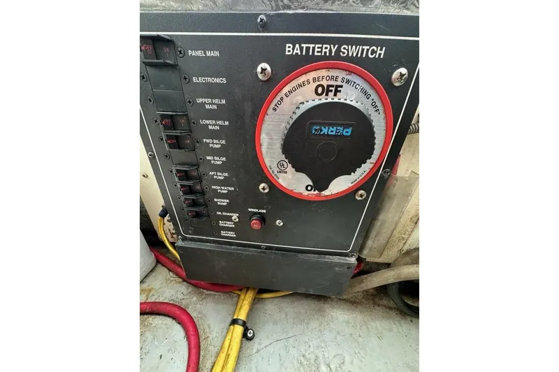 Slide: The Image of Battery switch panel on a 2002 Mainship Pilot 34 boat, featuring various control switches. - 33