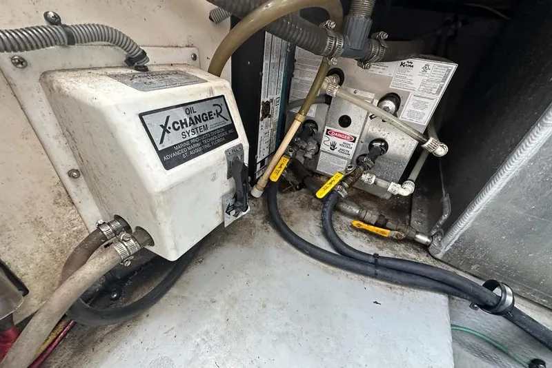 Slide: The Image of Engine room of 2002 Mainship Pilot 34 with oil change system and hoses. - 34