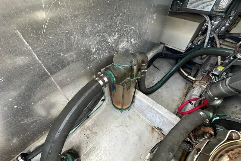 Slide: The Image of Engine compartment of a 2002 Mainship Pilot 34 with hoses and components. - 35