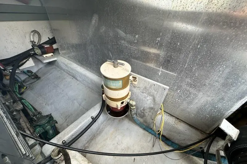 Slide: The Image of Engine compartment of a 2002 Mainship Pilot 34 boat, showing mechanical components. - 36