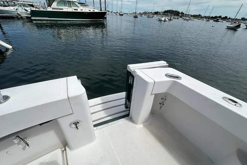 Slide: The Image of 2002 Mainship Pilot 34 boat deck with open transom door, docked in a marina. - 38