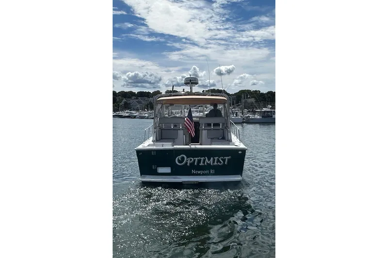 Slide: The Image of 2002 Mainship Pilot 34 boat named "Optimist" on water, Newport RI. - 7