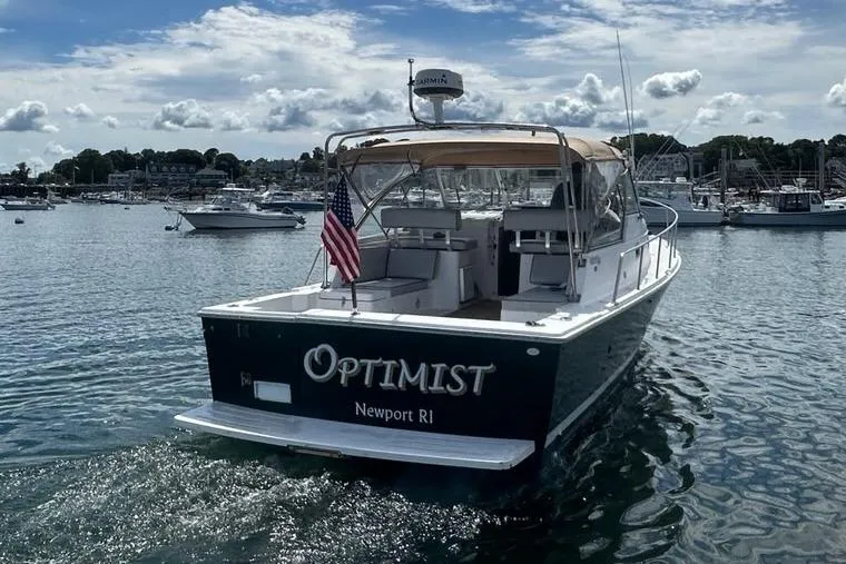 Slide: The Image of 2002 Mainship Pilot 34 boat named "Optimist" in scenic Newport harbor. - 8