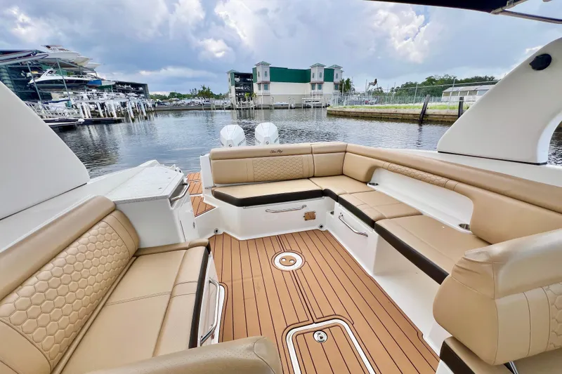 Slide: The Image of 2019 Sea Ray SDX 290 Outboard with spacious seating, docked at a marina. - 11
