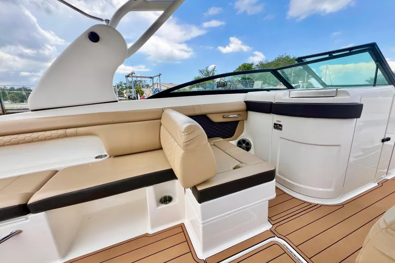 Slide: The Image of 2019 Sea Ray SDX 290 Outboard interior with beige seating and sleek design. - 15