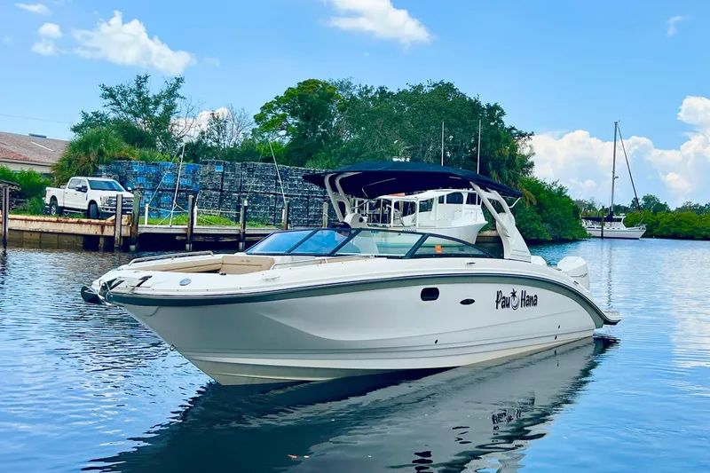 Slide: The Image of 2019 Sea Ray SDX 290 Outboard boat docked on a calm waterway. - 3