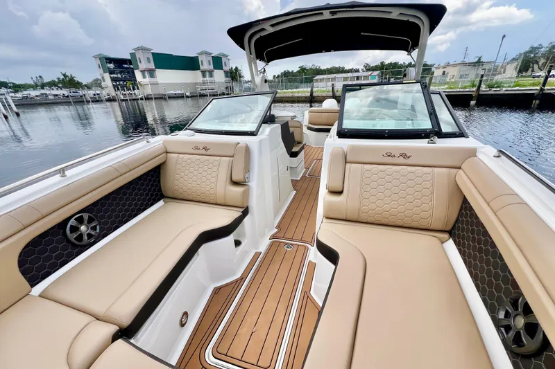 Slide: The Image of 2019 Sea Ray SDX 290 Outboard boat interior with tan seating and wood flooring. - 31