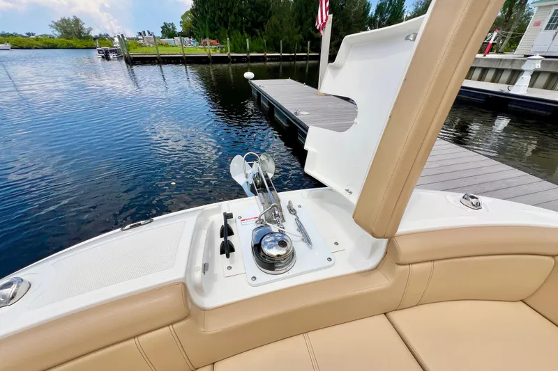 Slide: The Image of 2019 Sea Ray SDX 290 Outboard boat interior with tan seating and water view. - 32