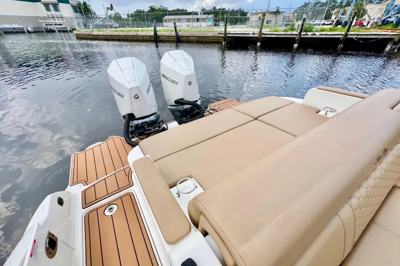 Slide: The Image of 2019 Sea Ray SDX 290 Outboard with twin Mercury engines on a calm waterway. - 8