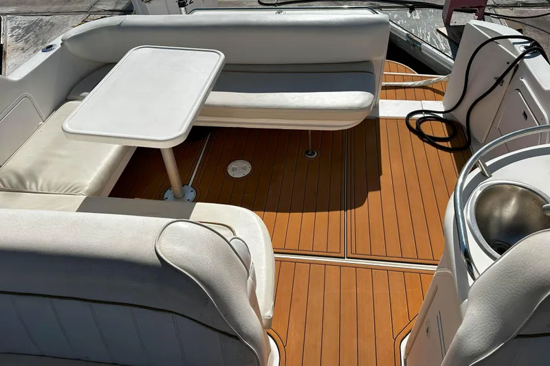 Slide: The Image of 1999 Sea Ray 330 Sundancer boat interior with seating, table, and sink. - 12