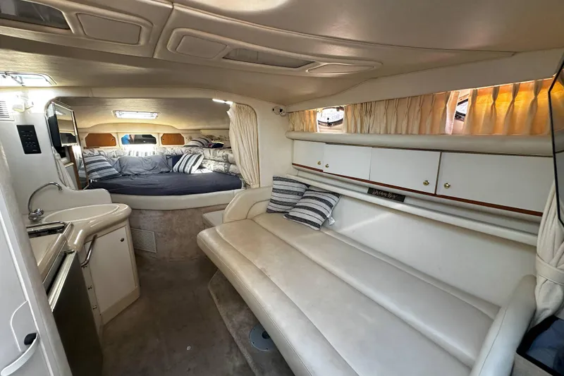 Slide: The Image of 1999 Sea Ray 330 Sundancer kitchen with stove and sink. - 21