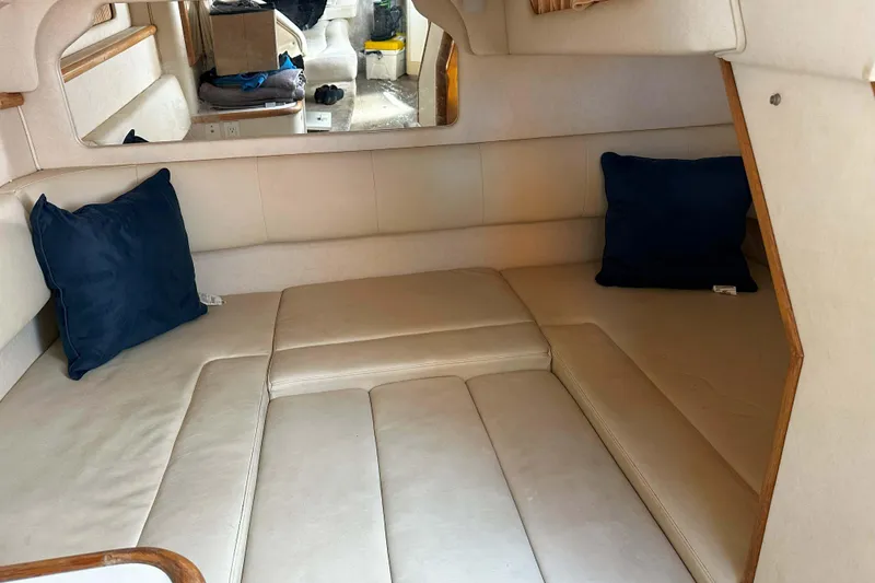 Slide: The Image of 1999 Sea Ray 330 Sundancer cabin interior with seating, bed, and kitchenette. - 24