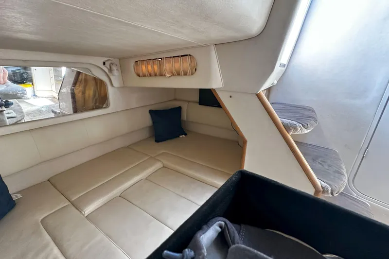 Slide: The Image of 1999 Sea Ray 330 Sundancer bathroom with toilet, sink, and porthole window. - 29