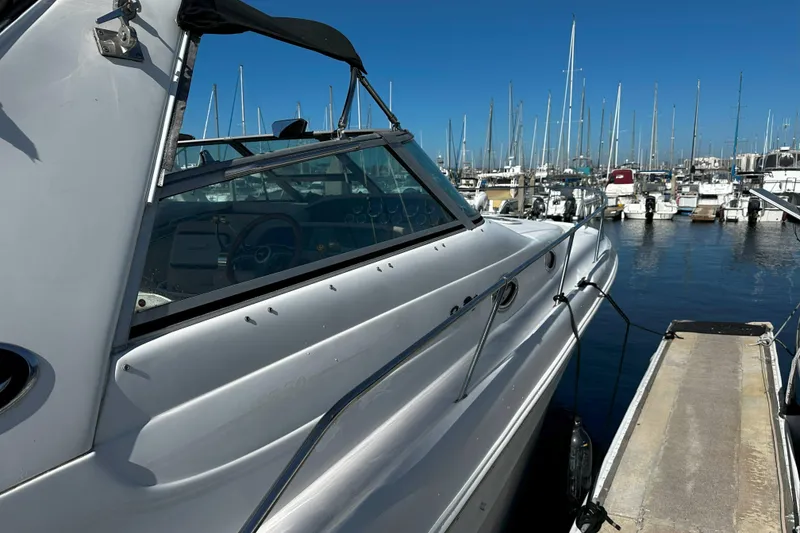 Slide: The Image of 1999 Sea Ray 330 Sundancer docked at marina with clear blue sky. - 3