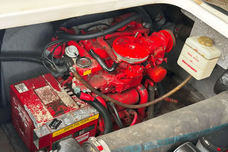 Slide: The Image of Engine compartment of a 1999 Sea Ray 330 Sundancer with red engine components. - 34