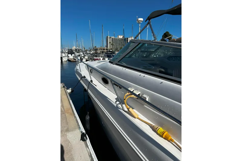 Slide: The Image of 1999 Sea Ray 330 Sundancer docked at marina under clear blue sky. - 5