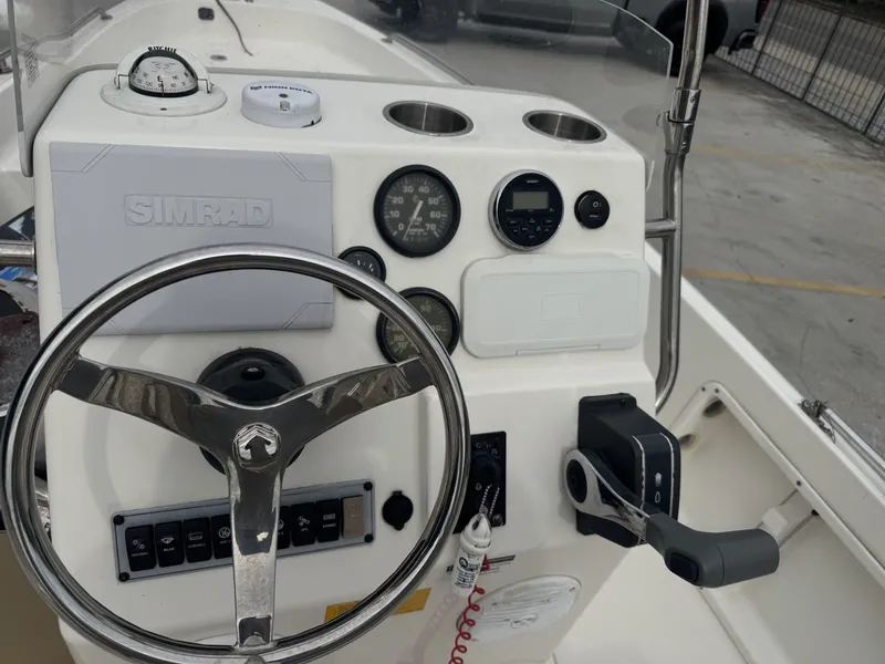 Slide: The Image of 2018 Key West 1720 Sportsman boat dashboard with steering wheel and controls. - 8
