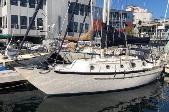 The Image of 1988 Pacific Seacraft 34 sailboat docked at marina, featuring classic design and white hull. - 0