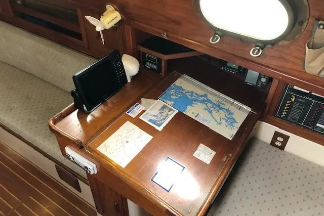 Slide: The Image of Navigation station on 1988 Pacific Seacraft 34 sailboat with maps and electronic equipment. - 12