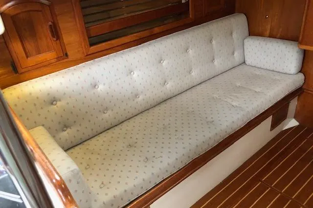 Slide: The Image of Interior of 1988 Pacific Seacraft 34 sailboat with cushioned seating and wooden accents. - 18