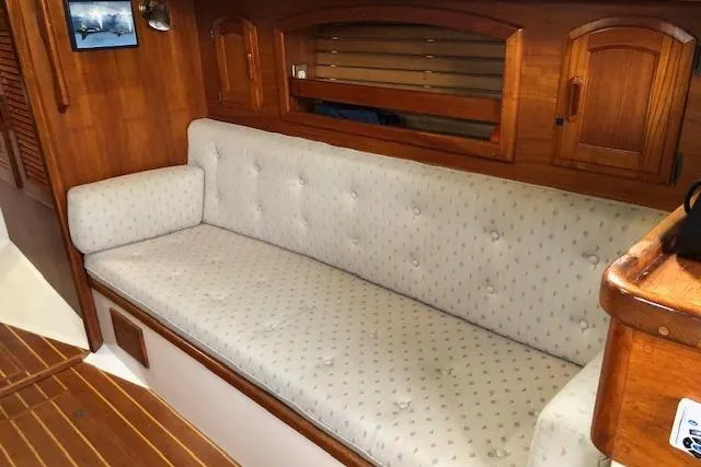 Slide: The Image of Interior of 1988 Pacific Seacraft 34 sailboat with cushioned seating and wooden cabinetry. - 19