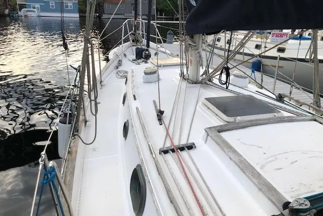 Slide: The Image of 1988 Pacific Seacraft 34 sailboat docked, showcasing deck and rigging details. - 2