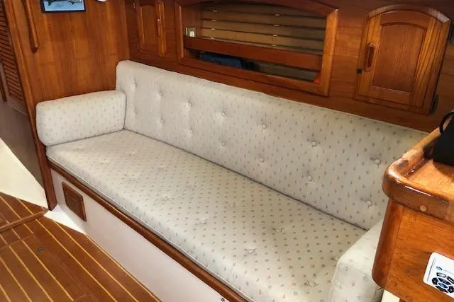 Slide: The Image of Interior of 1988 Pacific Seacraft 34 sailboat with cushioned seating and wooden cabinetry. - 20