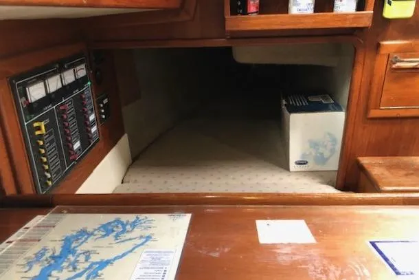 Slide: The Image of 1988 Pacific Seacraft 34 interior with navigation charts and control panel. - 22