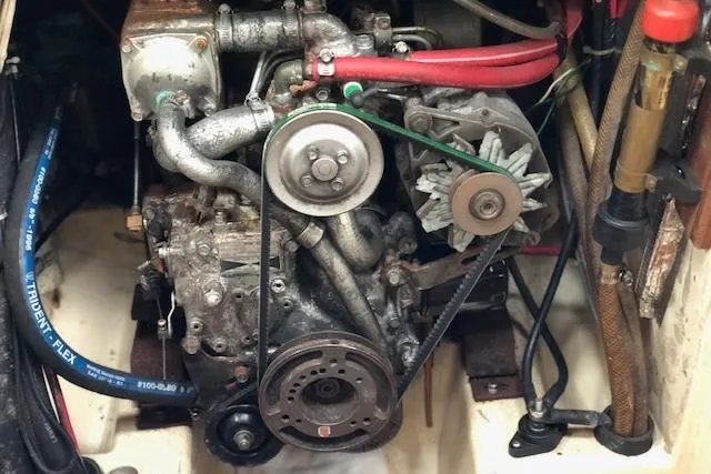 Slide: The Image of Engine compartment of a 1988 Pacific Seacraft 34 sailboat, showing mechanical components and belts. - 23