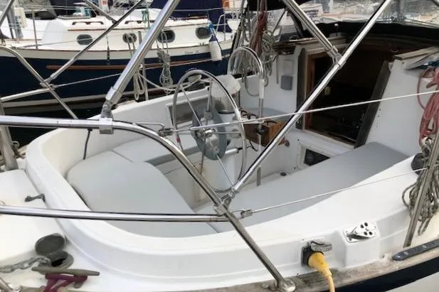 Slide: The Image of 1988 Pacific Seacraft 34 sailboat cockpit with steering wheel and seating area. - 8