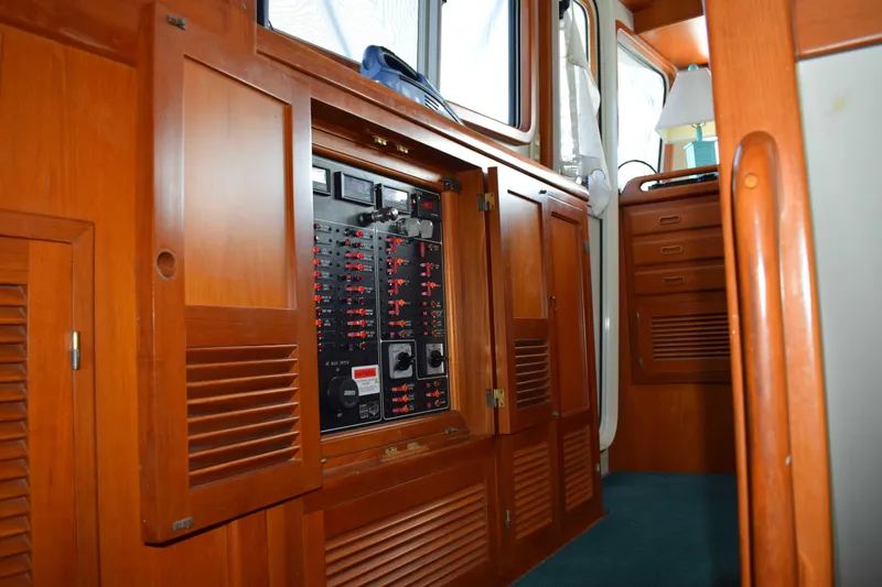Slide: The Image of Interior view of 2001 Kadey Krogen 48 yacht showing electrical panel and wooden cabinetry. - 10
