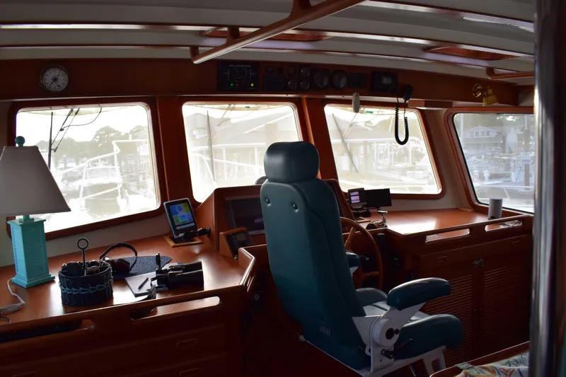 Slide: The Image of Interior of 2001 Kadey Krogen 48 yacht with navigation equipment and captain's chair. - 11