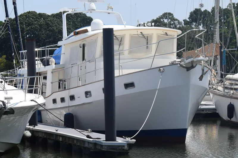 Slide: The Image of Kadey Krogen 48 yacht, 2001 model, docked at marina with surrounding boats. - 2