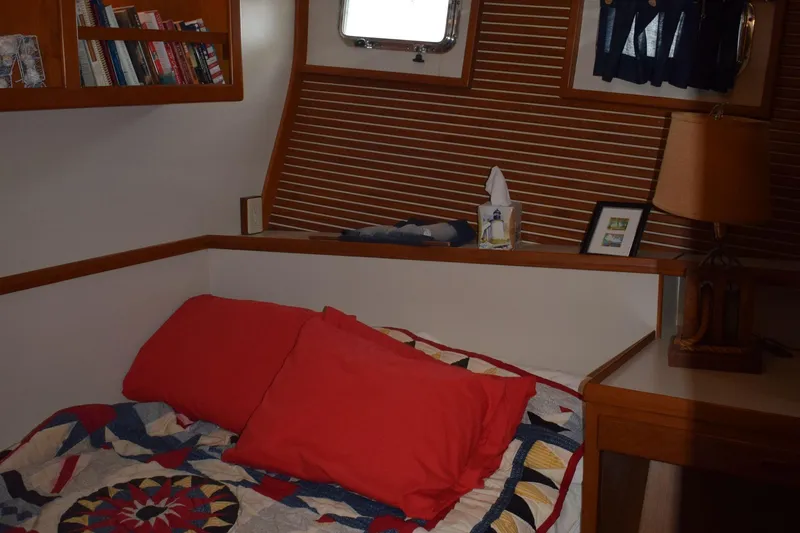 Slide: The Image of Cozy cabin interior of 2001 Kadey Krogen 48 with bed, books, and lamp. - 21