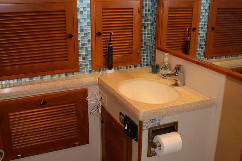 Slide: The Image of Kadey Krogen 48 yacht bathroom with wooden cabinets and modern sink, 2001 model. - 23