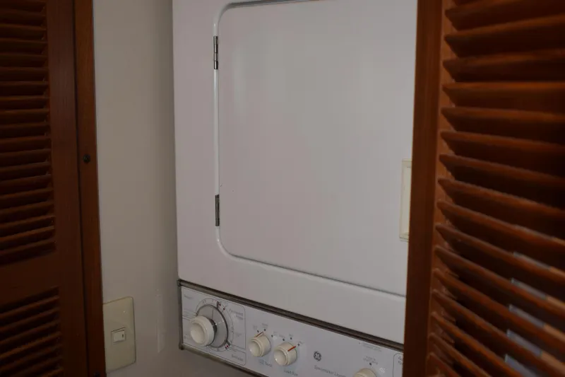Slide: The Image of Laundry area with a white dryer inside a Kadey Krogen 48 yacht, 2001 model. - 24