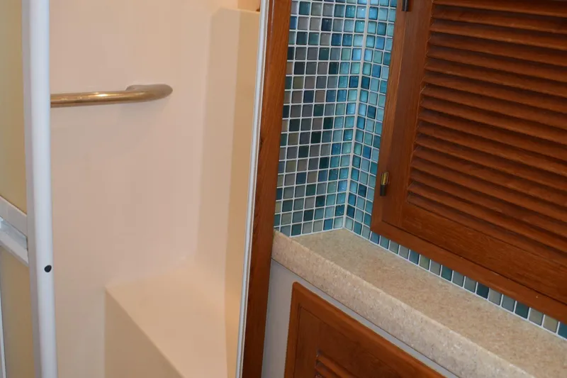 Slide: The Image of Bathroom interior of 2001 Kadey Krogen 48 with tiled wall and wooden cabinet. - 25