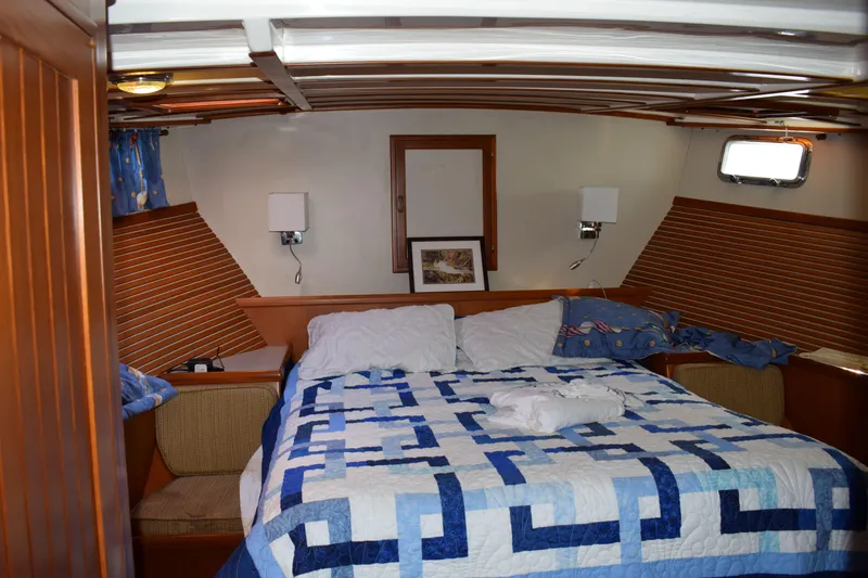 Slide: The Image of Cozy cabin interior of 2001 Kadey Krogen 48 with quilted bedspread and wooden accents. - 26