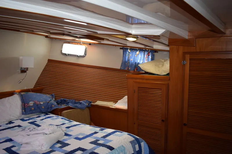 Slide: The Image of Cozy cabin interior of 2001 Kadey Krogen 48 yacht with wooden accents and nautical decor. - 27