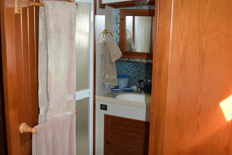 Slide: The Image of Bathroom interior of 2001 Kadey Krogen 48 yacht with towels and mirror. - 28