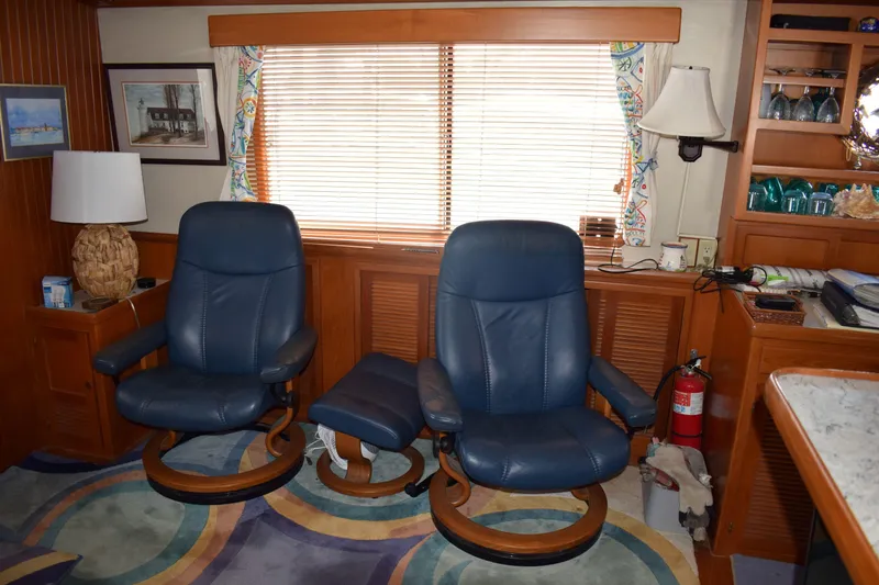Slide: The Image of Interior of 2001 Kadey Krogen 48 yacht with blue leather chairs and wooden accents. - 29