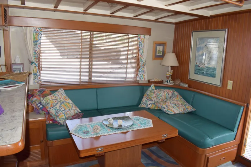 Slide: The Image of Cozy interior of 2001 Kadey Krogen 48 yacht with teal seating and nautical decor. - 32