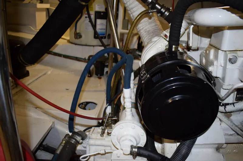 Slide: The Image of Engine room of 2001 Kadey Krogen 48 yacht with visible machinery and hoses. - 38